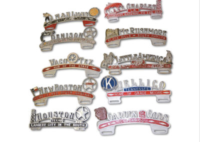 Ten Cast Aluminum License Plate Attachments - $ 300-$ 500