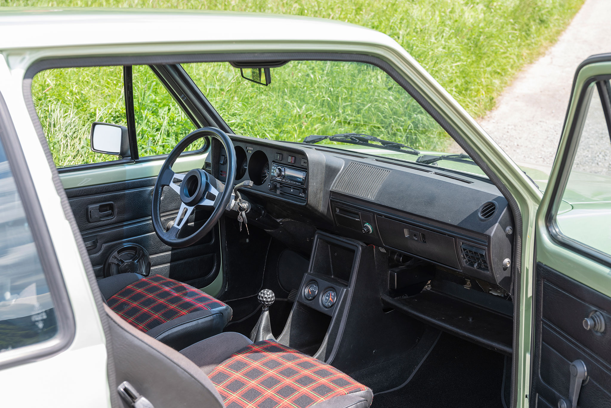 1980 Volkswagen Golf GTI – la balle de golf sur le levier de vitesses et le tissu à carreaux des sièges, toute une ambiance.